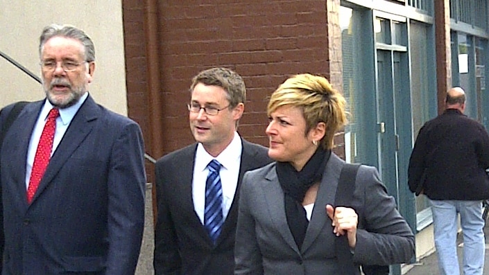 Former ABC television host Andy Muirhead (centre) arrives at Hobart  Magistrates Court.