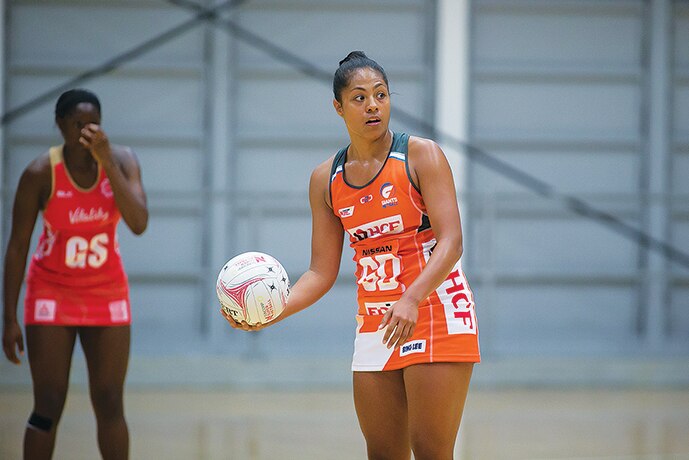 Kristiana Manu'a holds the ball with her right hand for the GWS Giants during a netball game in 2020.