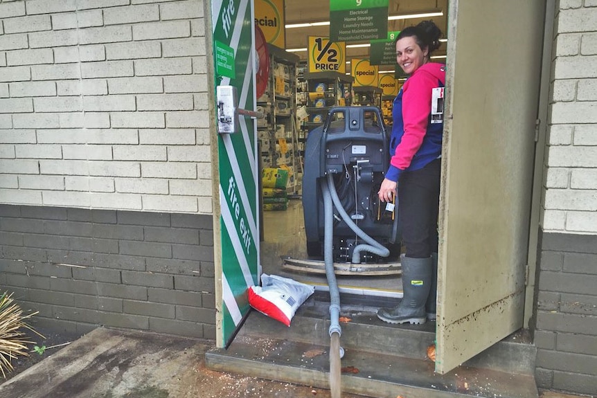 Water is pumped out of the supermarket damaged by flooding at Port Lincoln