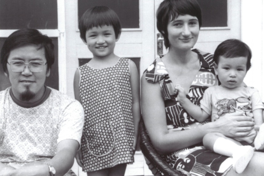 A black and white photograph of Penny Wong as a child, with her mother, father and brother.