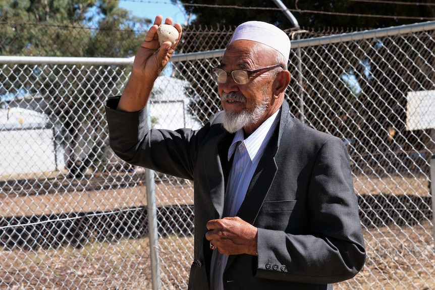 A man gets ready to throw a rock