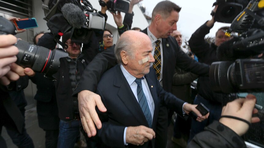 Suspended FIFA president Sepp Blatter is surrounded by journalists for a press conference in Zurich.