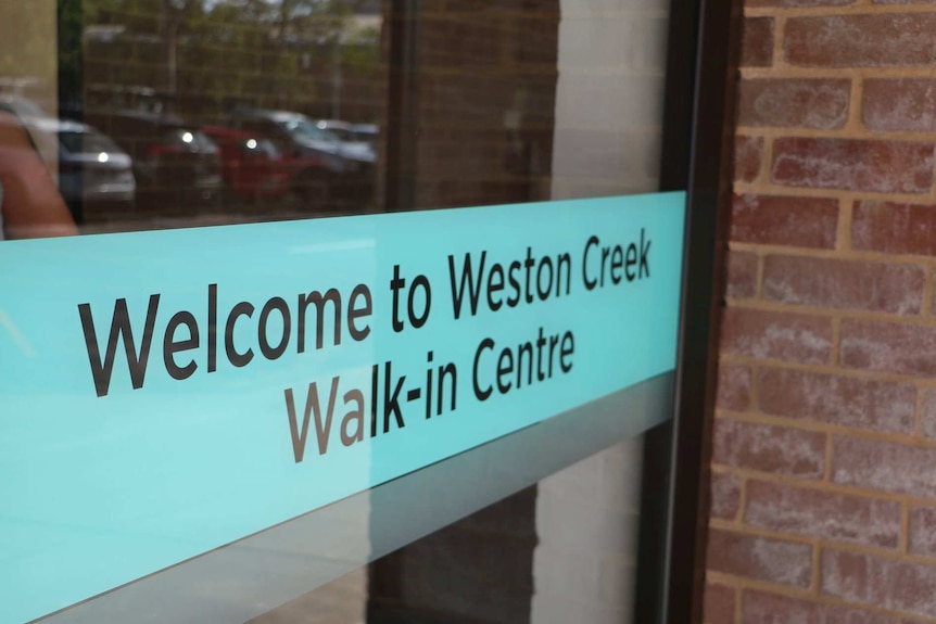 A door with signage reading: "Welcome to Weston Creek Walk-in Centre".