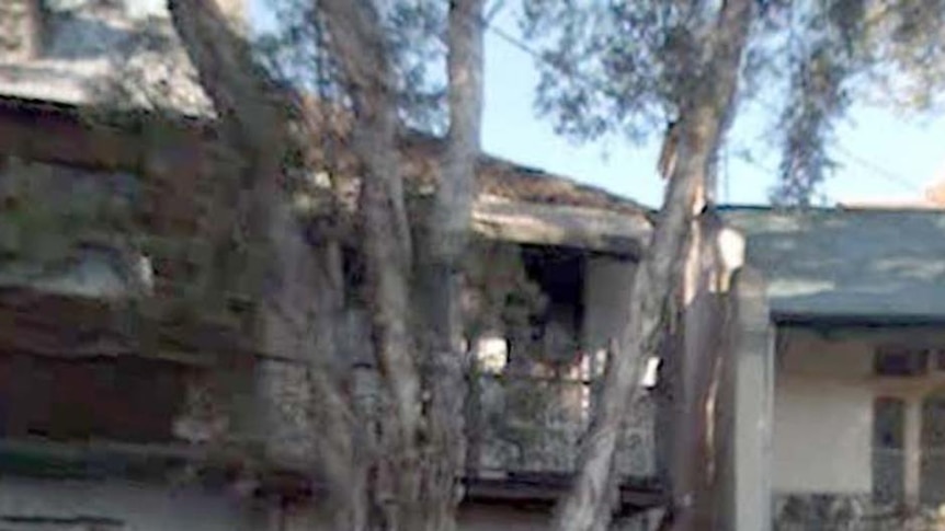 The woman's remains were found in her Surry Hills terrace house (centre) yesterday.