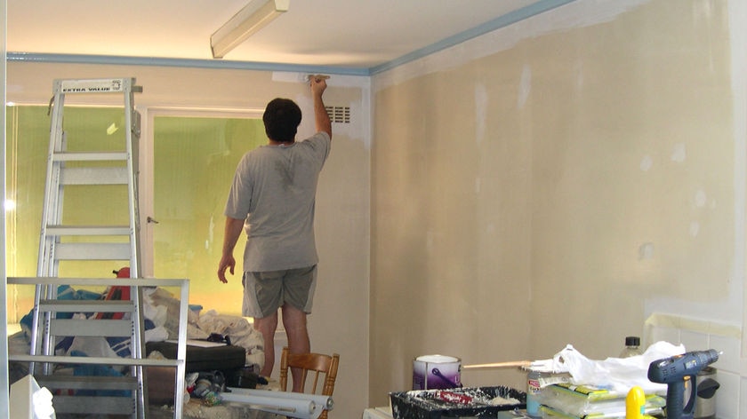 A man paints a wall.