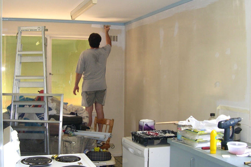 A man renovates a kitchen