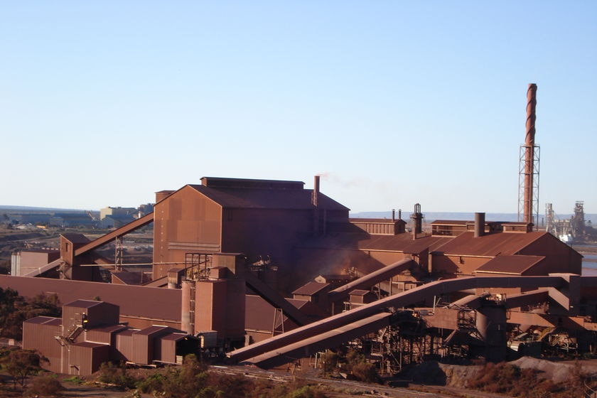 A drab-coloured steelworks beneath a pale sky.