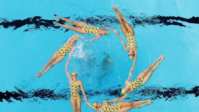 Members of the Australian Olympic synchronised swimming team in a crazy formation