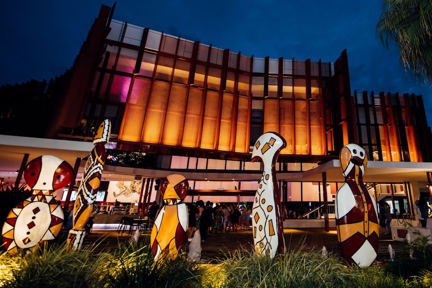 The Cairns Performing Arts Centre lit up at night.