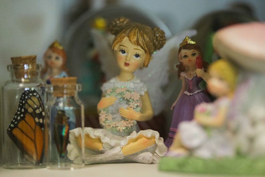 Ornament of fairy and princesses with small glass bottles and butterflies.