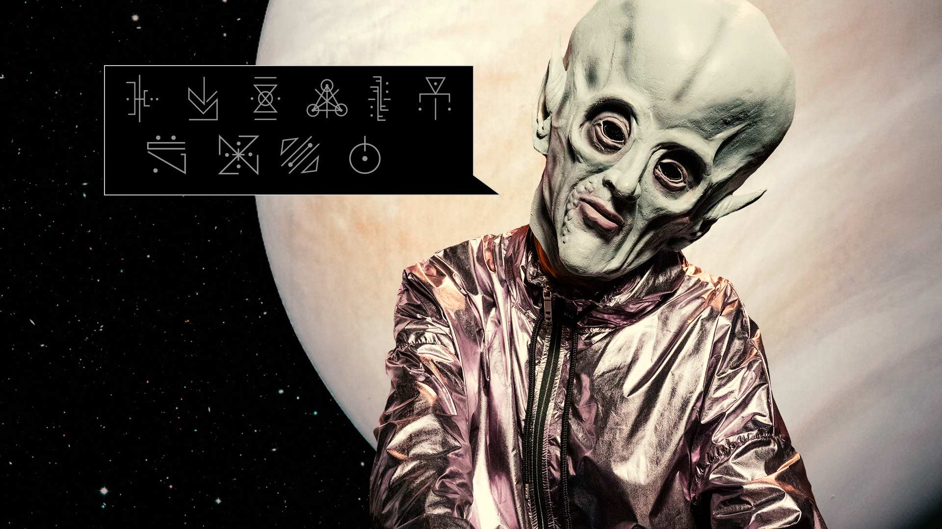 A speech bubble with alien writing next to a large headed alien and the planet Venus in the background.