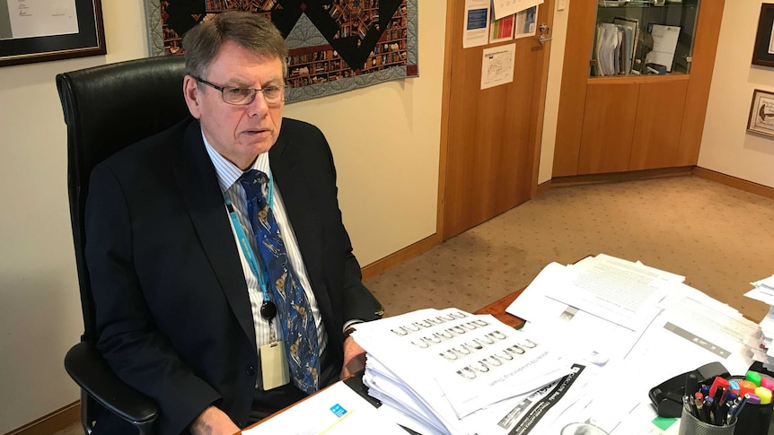 A man sits at a desk