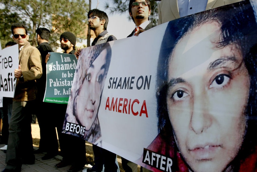 people at protest with banners