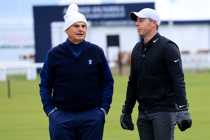 Jimmy Dunne and Rory McIlroy chat on a golf course