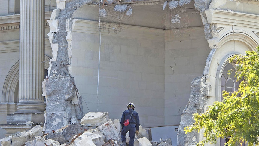 NZ quake: A rescue worker looks through the rubble of the Cathedral of Blessed Sacrament