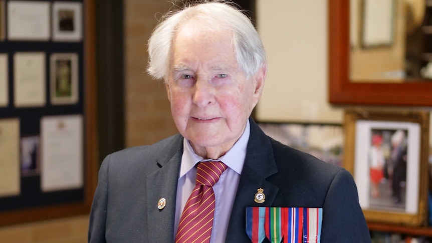 Veteran Bruce Robertson stands with his medals.