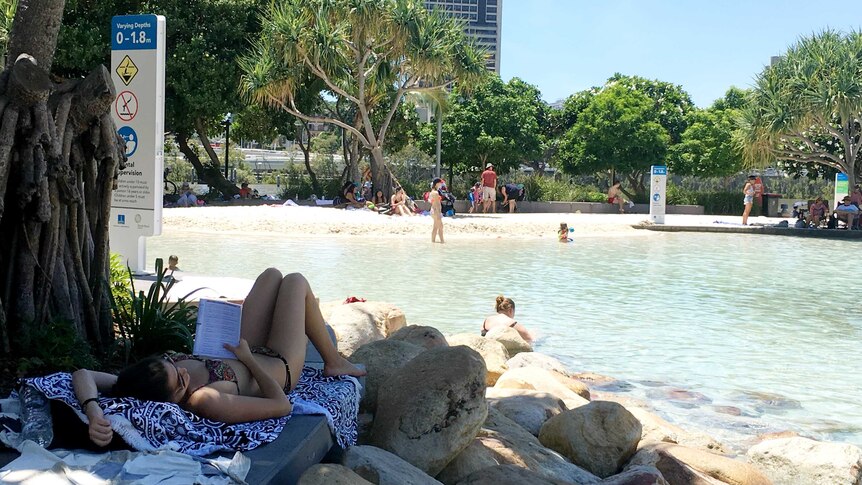 A woman lies in the shade during the heatwave