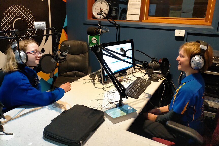 Ada Tracy and Irena Purnell sit opposite each other in radio studio.