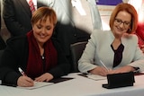 Tasmanian Premier Lara Giddings and PM Julia Gillard sign the NDIS agreement in Launceston.