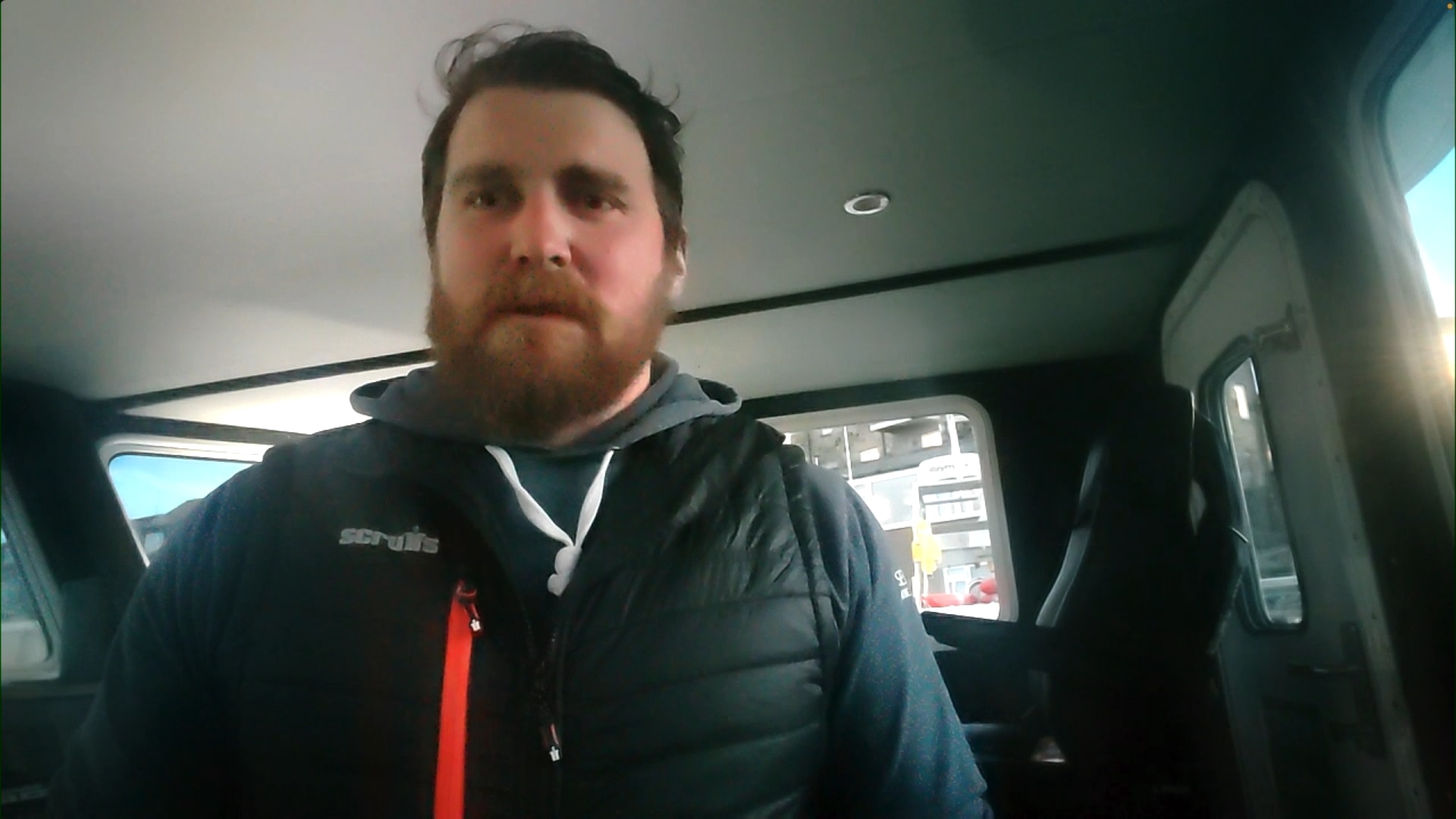 Skipper Jimmy Reid seated inside a car for a TV interview.