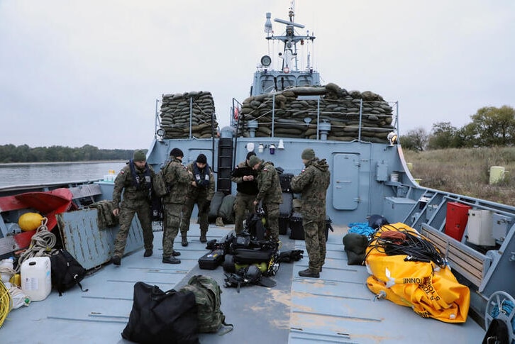 Navy divers from the 12th Minesweeper Squadron of the 8th Coastal Defense Flotilla take part in an operation.