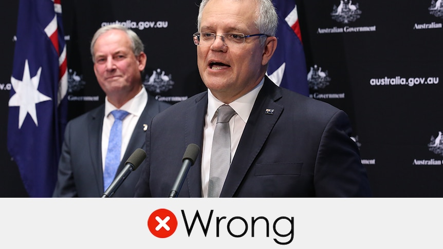 Scott Morrison speaking with Richard Colbeck out of focus behind. Verdict: wrong with a red cross
