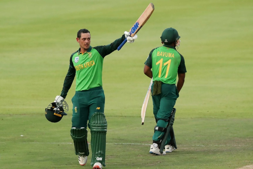 A South African player raises his bat and points it toward the dressing room after scoring 100.