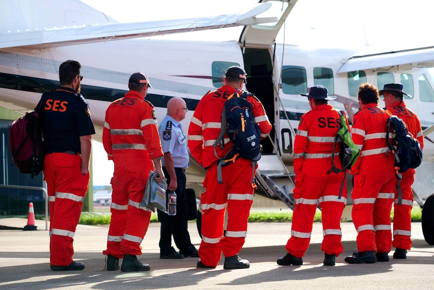 SES volunteers in Cairns prepare to board a plane.