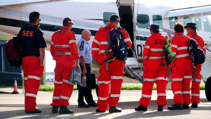 SES volunteers in Cairns prepare to board a plane.
