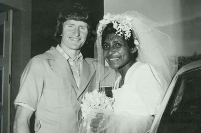 Black and white photo of Dorney in safari suit and Pauline in white wedding dress and veil.