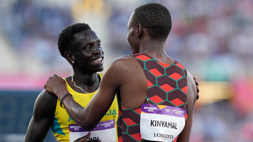 Australian runner Peter Bol smiles as he talks with Kenyan 800m champion Wyclife Kinyamal after a race.