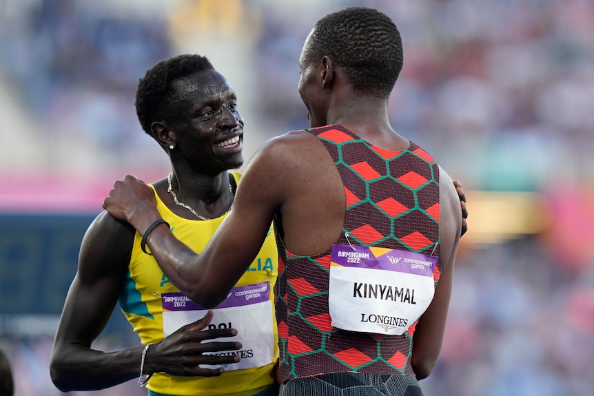 Australian runner Peter Bol smiles as he talks with Kenyan 800m champion Wyclife Kinyamal after a race.