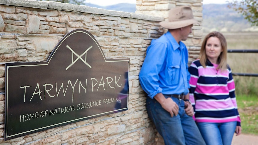 Stuart and Megan Andrews stand next to the sign for the Tarwyn Park property