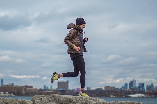 Unidentified woman jogging in a puffer jacket