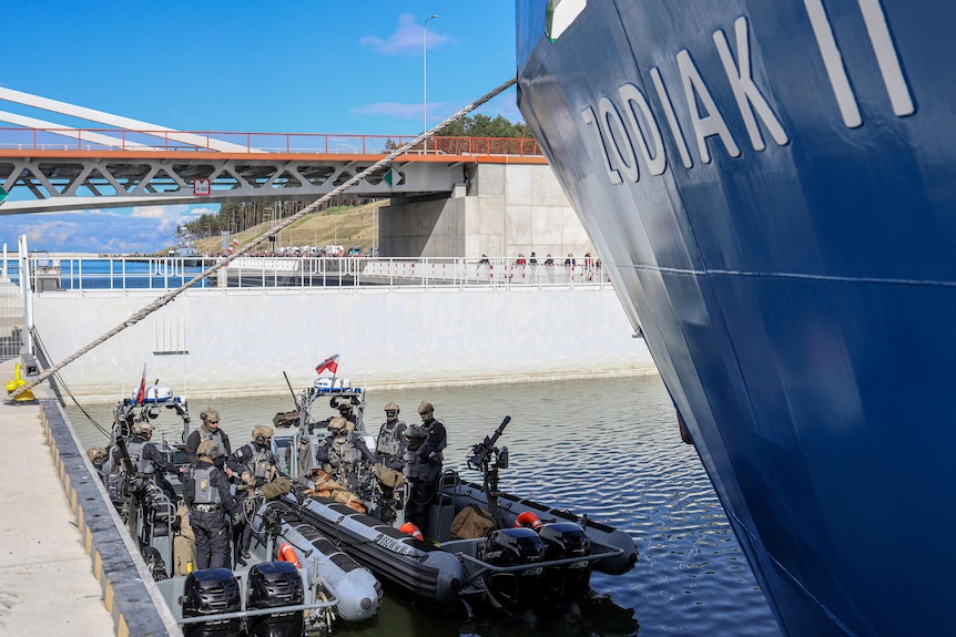 Members of the Special Forces of Military Police in two boats, on the right hand side the name of the ship Zodiak II.