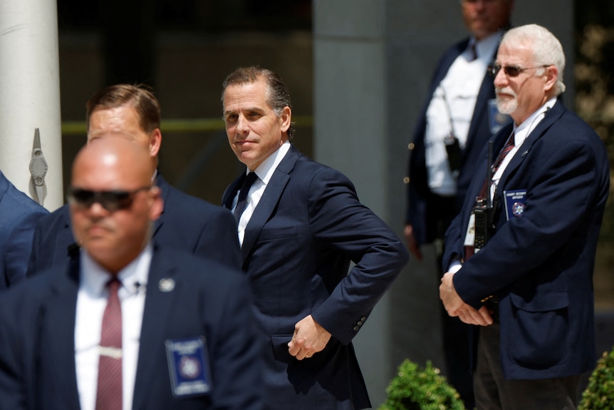 Hunter Biden, wearing suits, departs federal court after a plea hearing 