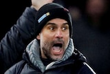 Manchester City Pep Guardiola shouts at the fourth official. An assistant stands behind him with his arms in the air.
