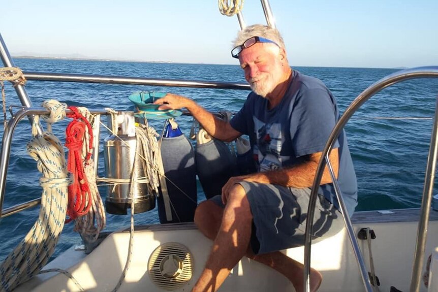 Headshot photo of smiling Andrew Heard on his yacht