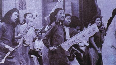 Female students in China protest, some holding banners, as part of the May Fourth Movement in 1919.