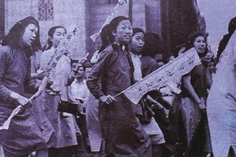 Female students in China protest, some holding banners, as part of the May Fourth Movement in 1919.