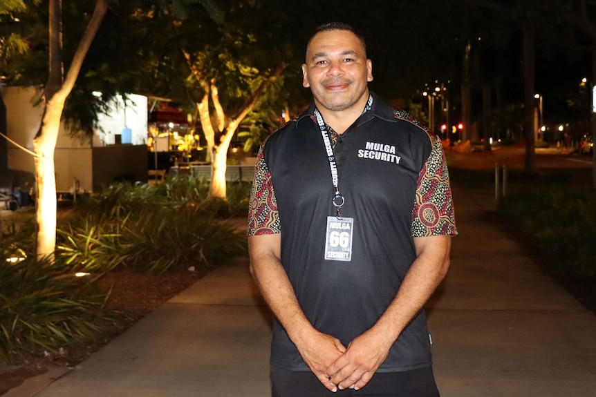 Shannon Brahim smiles at the camera on a Palmerston street in the evening.