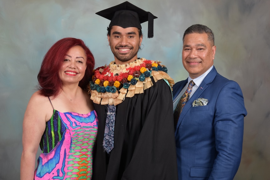 Simione and his parents at graduation.