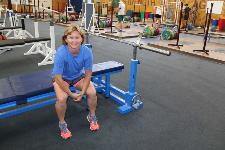 Darlene Brown sits on weight training equipment at the AIS gym in Canberra.