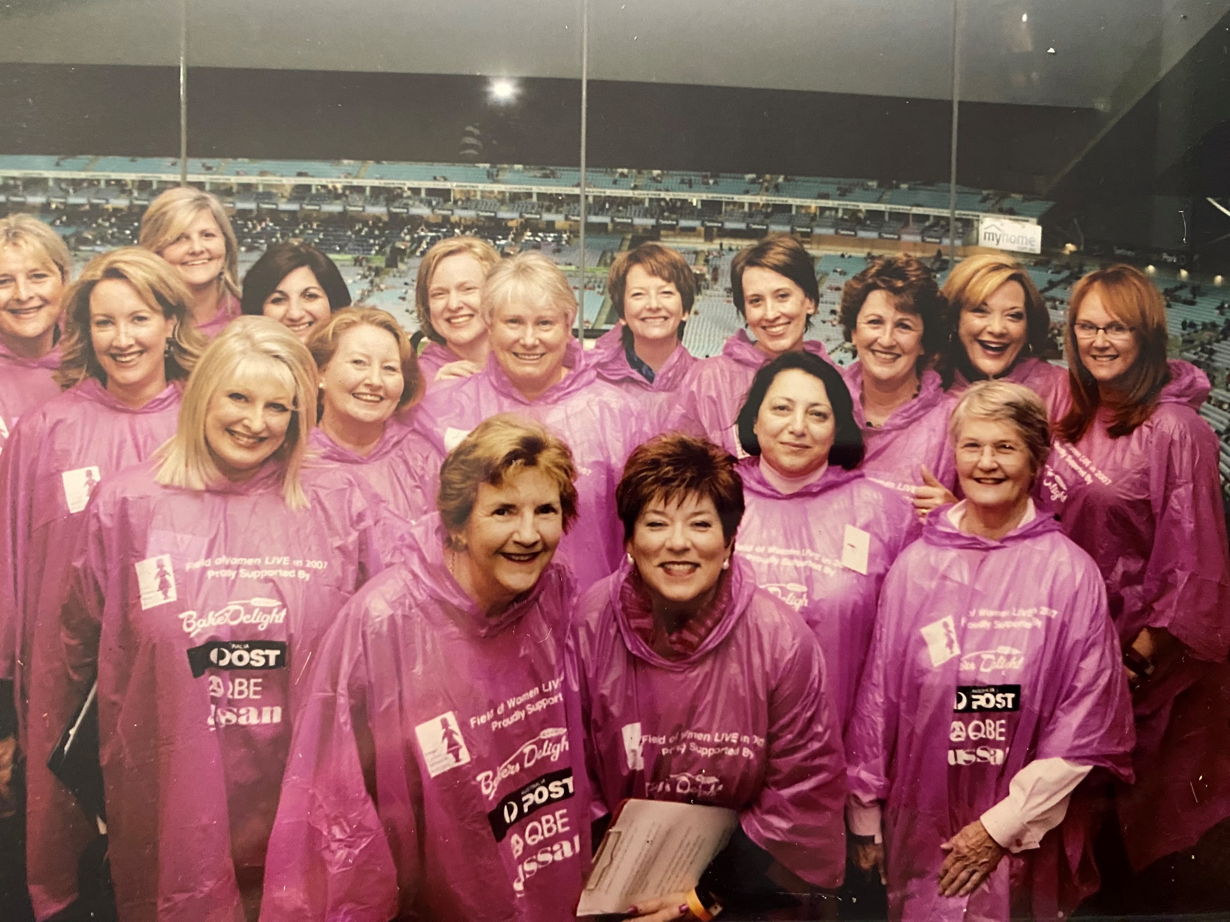 A group of women in pink rain ponchos 