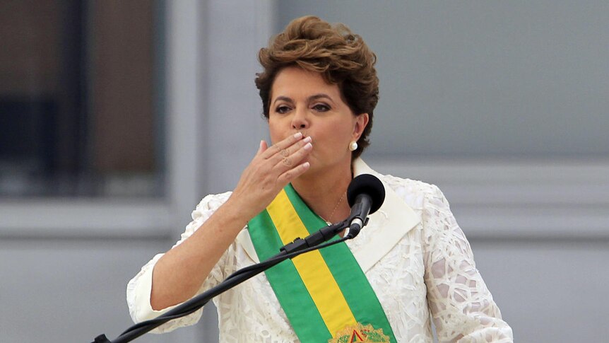 Brazil's president Dilma Rousseff blows a kiss to the public while giving a speech