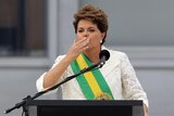 Brazil's president Dilma Rousseff blows a kiss to the public while giving a speech