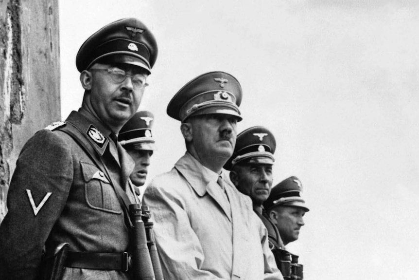 A black and white image of a group of Nazis looking off in the distance