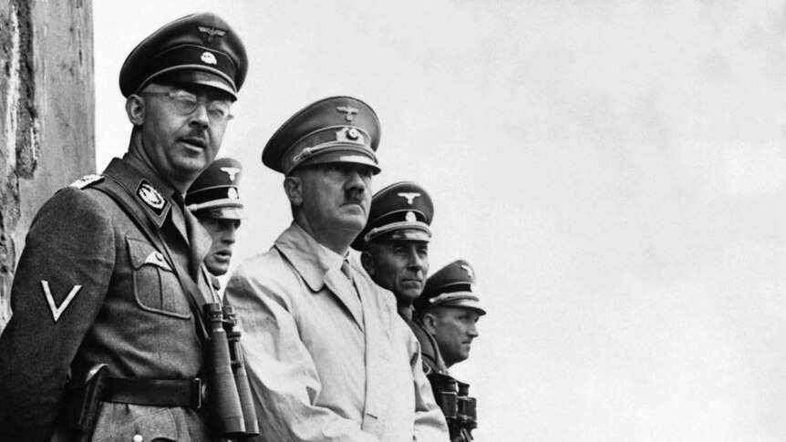 A black and white image of a group of Nazis looking off in the distance