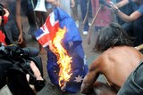 Protesters burn the Australian flag