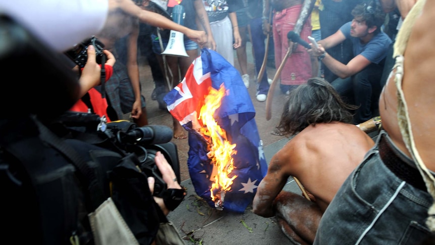 Protesters burn the Australian flag